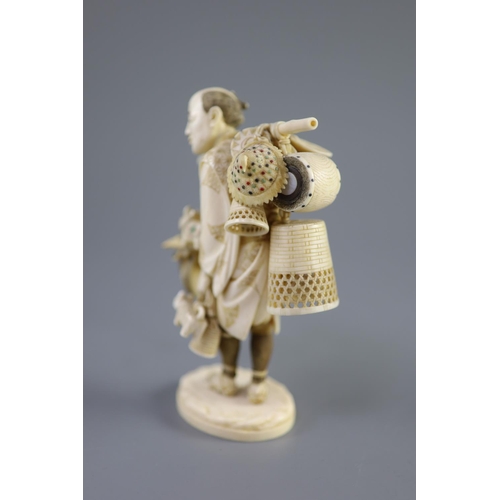 86 - A Japanese ivory okimono of a basket seller, early 20th centuryhis wares with polychrome inlay, two ... 