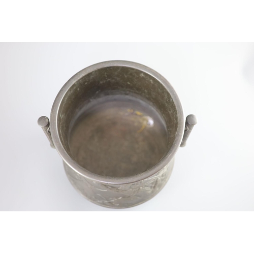 89 - A Japanese archaistic bronze two-handled vessel, Meiji periodcast in high relief with men hanging fr... 