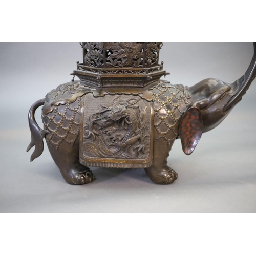 92 - An impressive Japanese bronze elephant koro, 19th century,modelled as a caparisoned elephant surmo... 