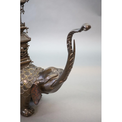 92 - An impressive Japanese bronze elephant koro, 19th century,modelled as a caparisoned elephant surmo... 