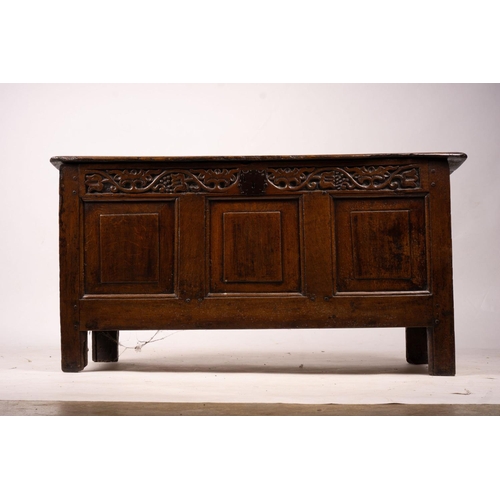 1064 - A 17th / 18th century carved oak coffer, length 132cm, depth 53cm, height 64cm