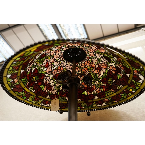 17 - A bronzed finish Tiffany style standard lamp with shade, 160cm high, 59cm diameter