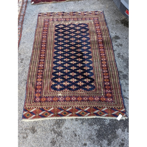 18 - A Bokhara blue ground rug, 191 x 126cm