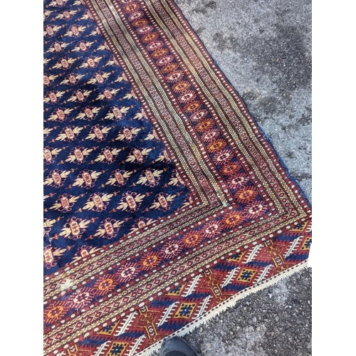 18 - A Bokhara blue ground rug, 191 x 126cm