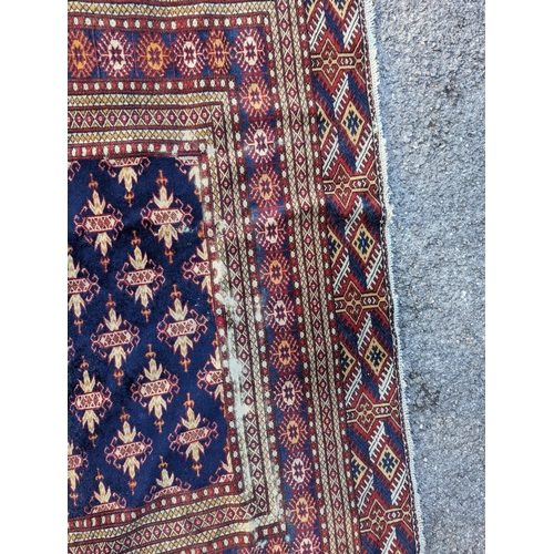 18 - A Bokhara blue ground rug, 191 x 126cm