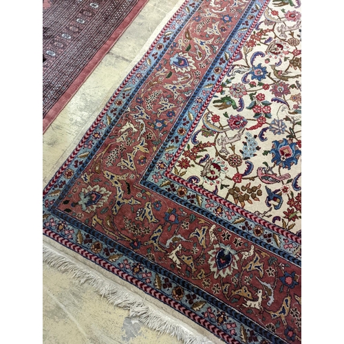 10 - An Ispahan ivory ground carpet woven with flowers and animals, 386 x 276cm