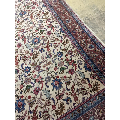 10 - An Ispahan ivory ground carpet woven with flowers and animals, 386 x 276cm