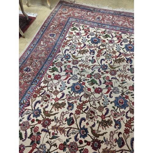 10 - An Ispahan ivory ground carpet woven with flowers and animals, 386 x 276cm