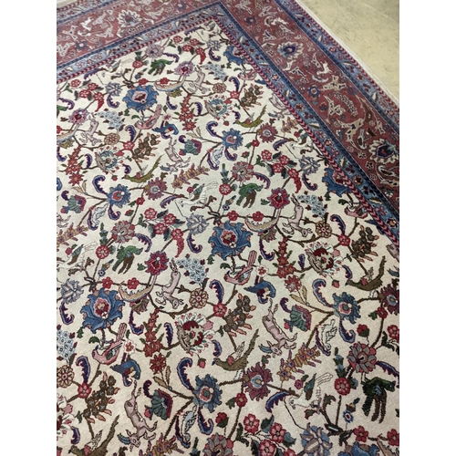 10 - An Ispahan ivory ground carpet woven with flowers and animals, 386 x 276cm