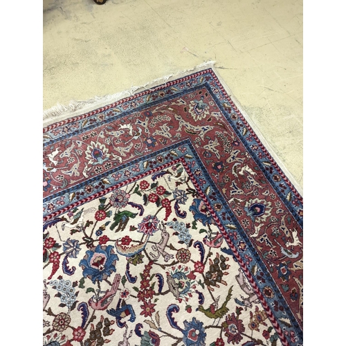 10 - An Ispahan ivory ground carpet woven with flowers and animals, 386 x 276cm