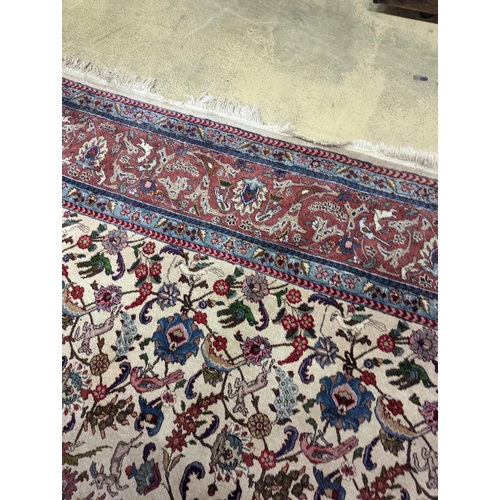 10 - An Ispahan ivory ground carpet woven with flowers and animals, 386 x 276cm