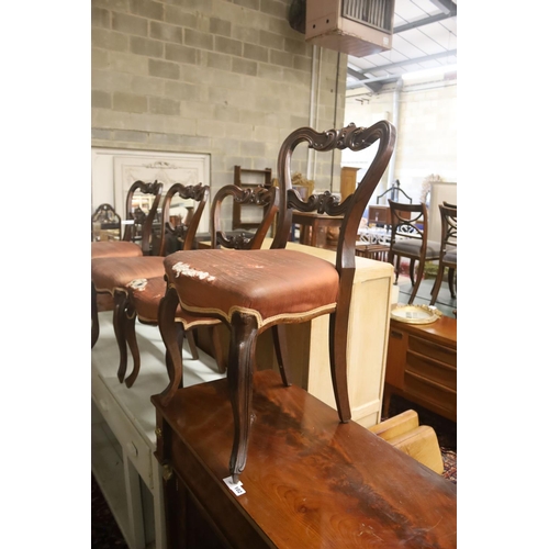 100 - A set of six Victorian carved rosewood balloon back dining chairs