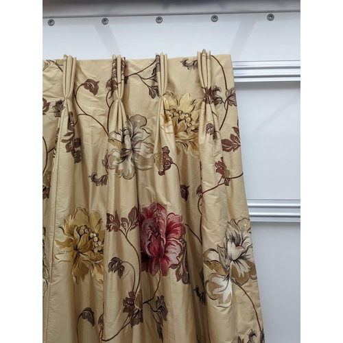 109 - A pair of floral lined curtains. Approximate measurements: Width of top 110cm, Width of bottom 220cm... 