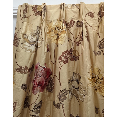 109 - A pair of floral lined curtains. Approximate measurements: Width of top 110cm, Width of bottom 220cm... 