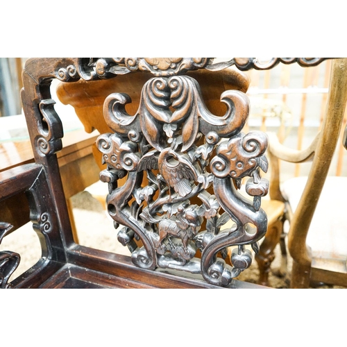 113 - A pair of Chinese carved hongmu elbow chairs (a.f.), width 65cm, depth 48cm, height 96cm... 