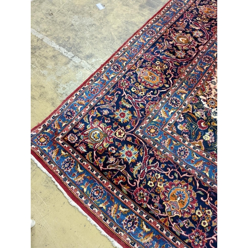 114 - A large Tabriz red ground floral carpet, 540 x 350cm