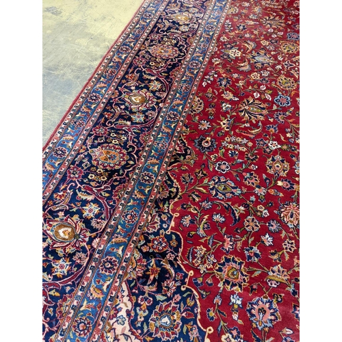 114 - A large Tabriz red ground floral carpet, 540 x 350cm