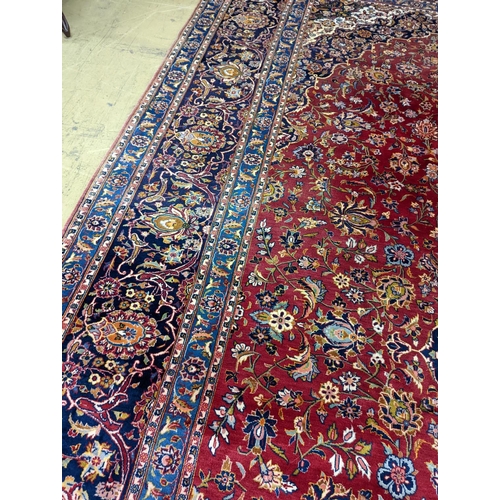 114 - A large Tabriz red ground floral carpet, 540 x 350cm