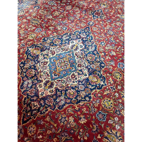 114 - A large Tabriz red ground floral carpet, 540 x 350cm