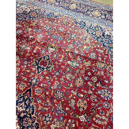 114 - A large Tabriz red ground floral carpet, 540 x 350cm