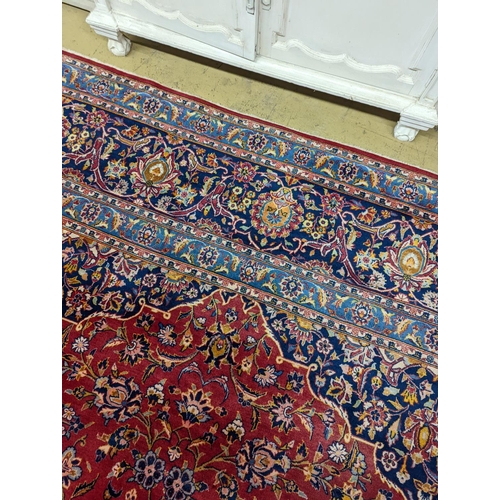 114 - A large Tabriz red ground floral carpet, 540 x 350cm