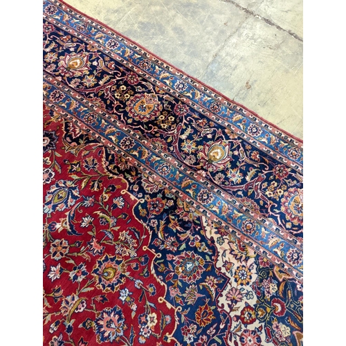 114 - A large Tabriz red ground floral carpet, 540 x 350cm