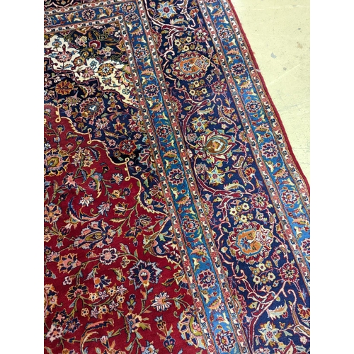 114 - A large Tabriz red ground floral carpet, 540 x 350cm