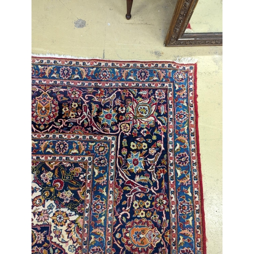 114 - A large Tabriz red ground floral carpet, 540 x 350cm