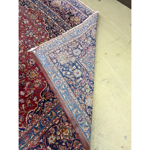 114 - A large Tabriz red ground floral carpet, 540 x 350cm