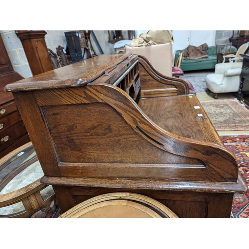 132 - An early 20th century oak roll top desk with 'S' shaped tambour, width 106cm, depth 75cm, height 119... 