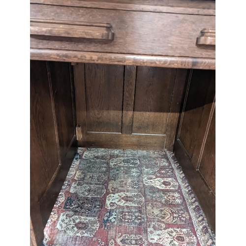 132 - An early 20th century oak roll top desk with 'S' shaped tambour, width 106cm, depth 75cm, height 119... 