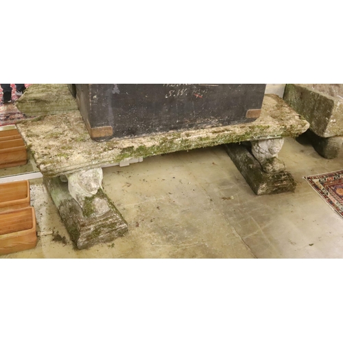 142 - A pair of reconstituted stone garden benches of curved rectangular form with recumbent lion supports... 