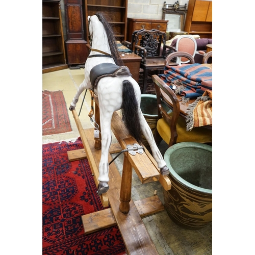 152 - A Victorian style dapple grey rocking horse on pine stand, length 152cm, height 126cm