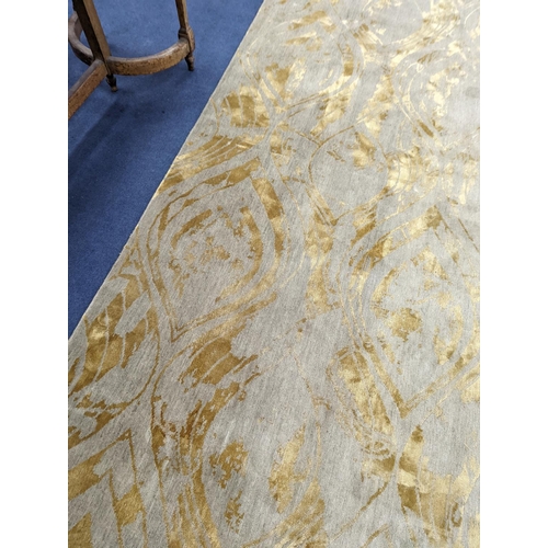 153 - A contemporary 'Son' Nepalese wool and silk stone grey and gold carpet, 490 x 270cm