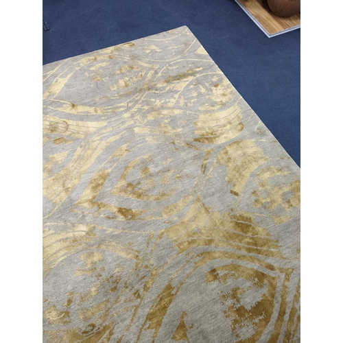 153 - A contemporary 'Son' Nepalese wool and silk stone grey and gold carpet, 490 x 270cm