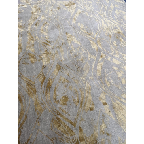 153 - A contemporary 'Son' Nepalese wool and silk stone grey and gold carpet, 490 x 270cm