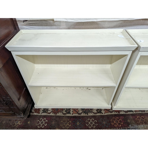 16 - A pair of modern white painted dwarf open bookcases, length 90cm, depth 30cm, height 82cm... 