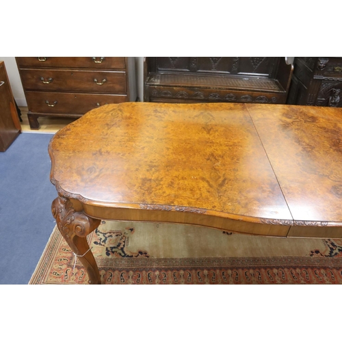 172 - A Queen Anne revival burr walnut shaped oval extending dining table, 272cm extended, one spare leaf,... 