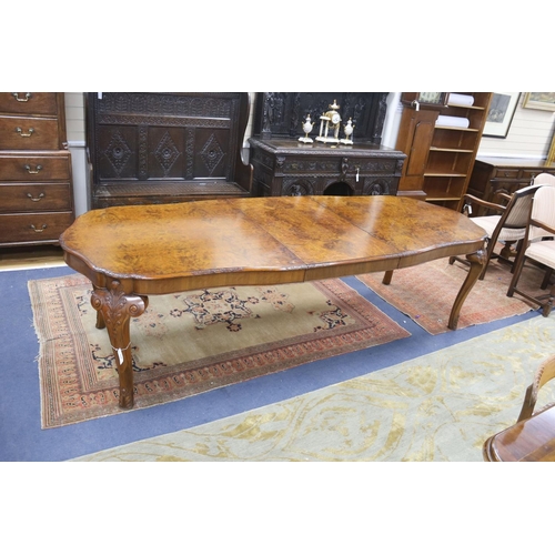 172 - A Queen Anne revival burr walnut shaped oval extending dining table, 272cm extended, one spare leaf,... 