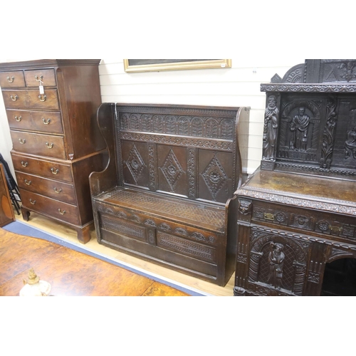 181 - An 18th century and later carved oak settle with hinged box seat, width 137, depth 42, height 137 cm... 