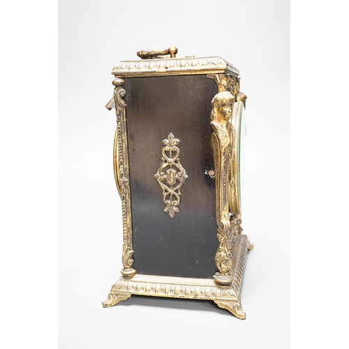 253 - A 19th century French ebonised and ormolu-mounted mantel clock with key, 27cm including handle... 