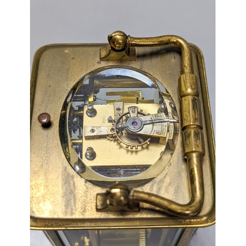 289 - A French brass repeating carriage clock with key. 13.5cm