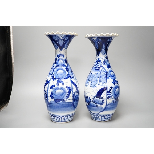 303 - Two provincial Chinese blue and white jars and a pair of Japanese vases 32cm