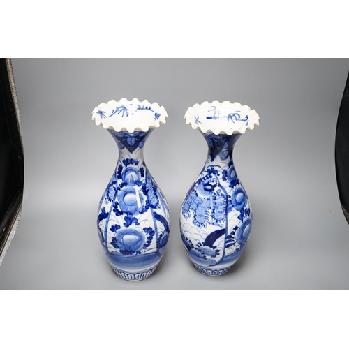 303 - Two provincial Chinese blue and white jars and a pair of Japanese vases 32cm