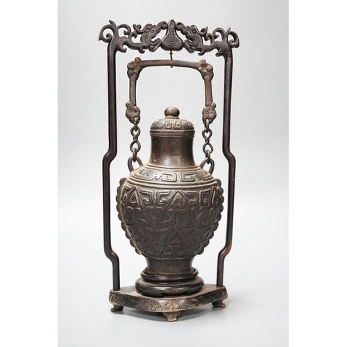 313 - A Chinese archaistic bronze hanging vessel, wood stand 34cm