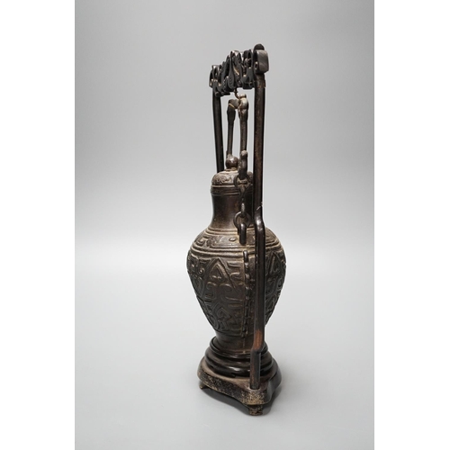 313 - A Chinese archaistic bronze hanging vessel, wood stand 34cm