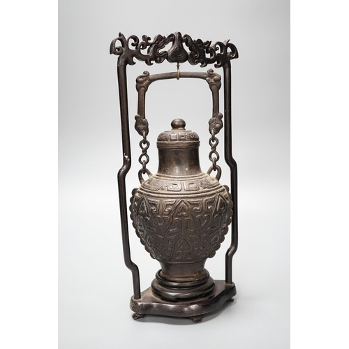 313 - A Chinese archaistic bronze hanging vessel, wood stand 34cm