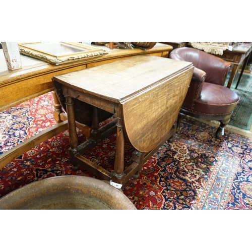 33 - An 18th century style oak gateleg dining table, length 148cm extended, width 105cm, height 76cm... 