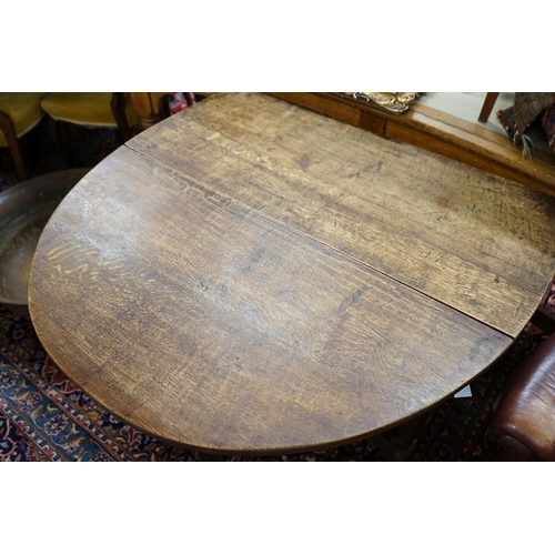 33 - An 18th century style oak gateleg dining table, length 148cm extended, width 105cm, height 76cm... 