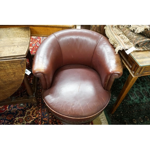 34 - A late Victorian mahogany burgundy leather tub frame swivel desk chair, width 72cm, depth 62cm, heig... 